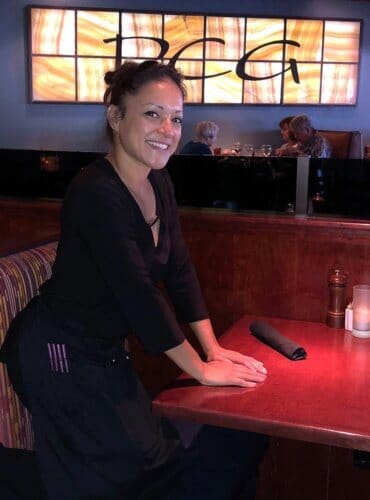 A woman standing in a pcg table