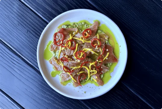 A dish with chili slices on top